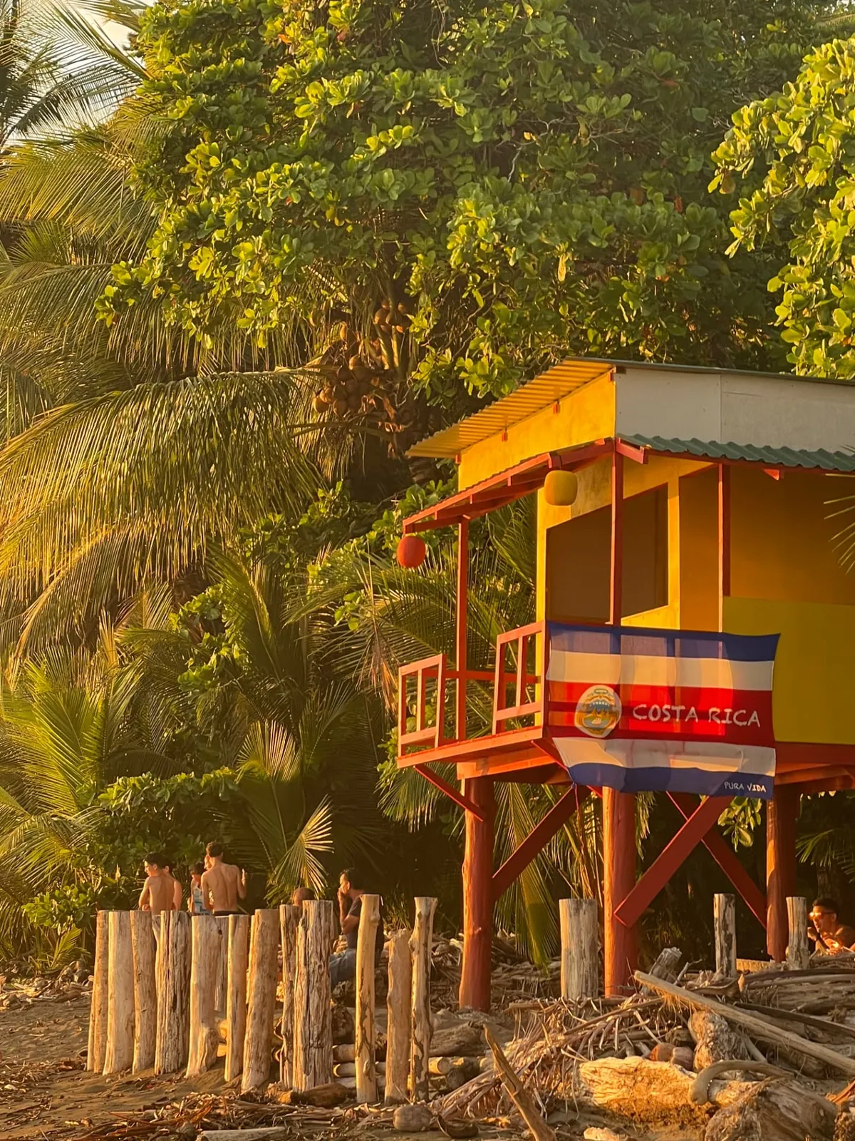 Colorful lifeguard tower with the Costa Rica flag at Playa Dominical in golden light